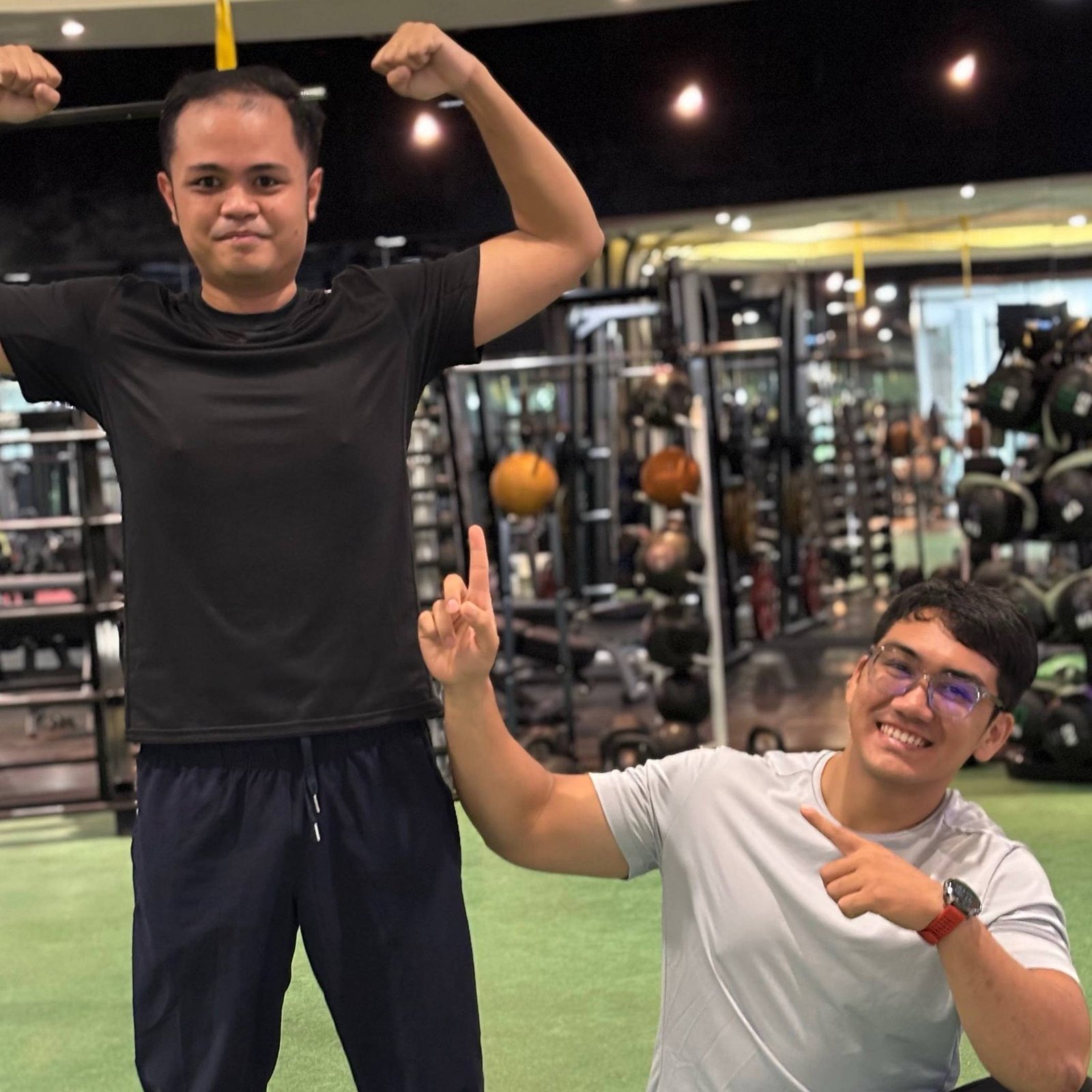 Faris and a client posing together at the gym