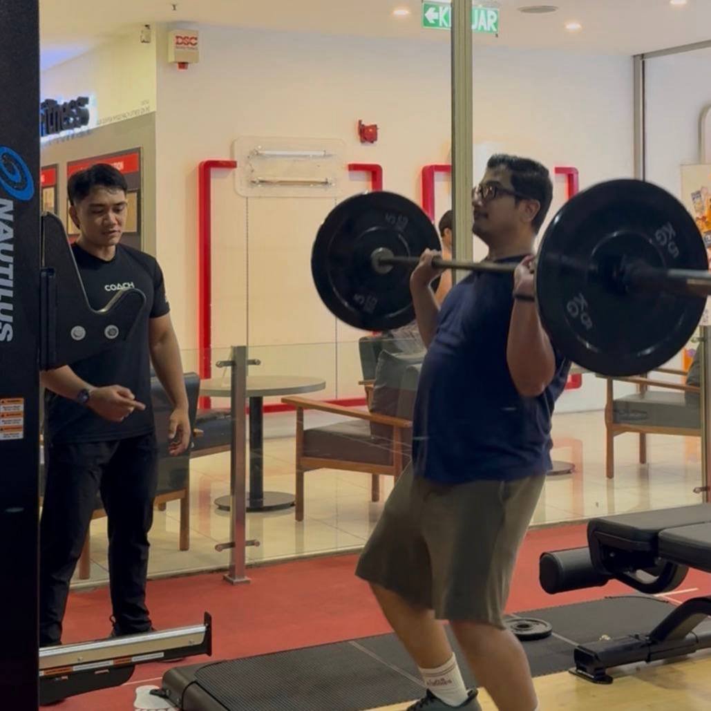 Faris observing a client’s barbell technique