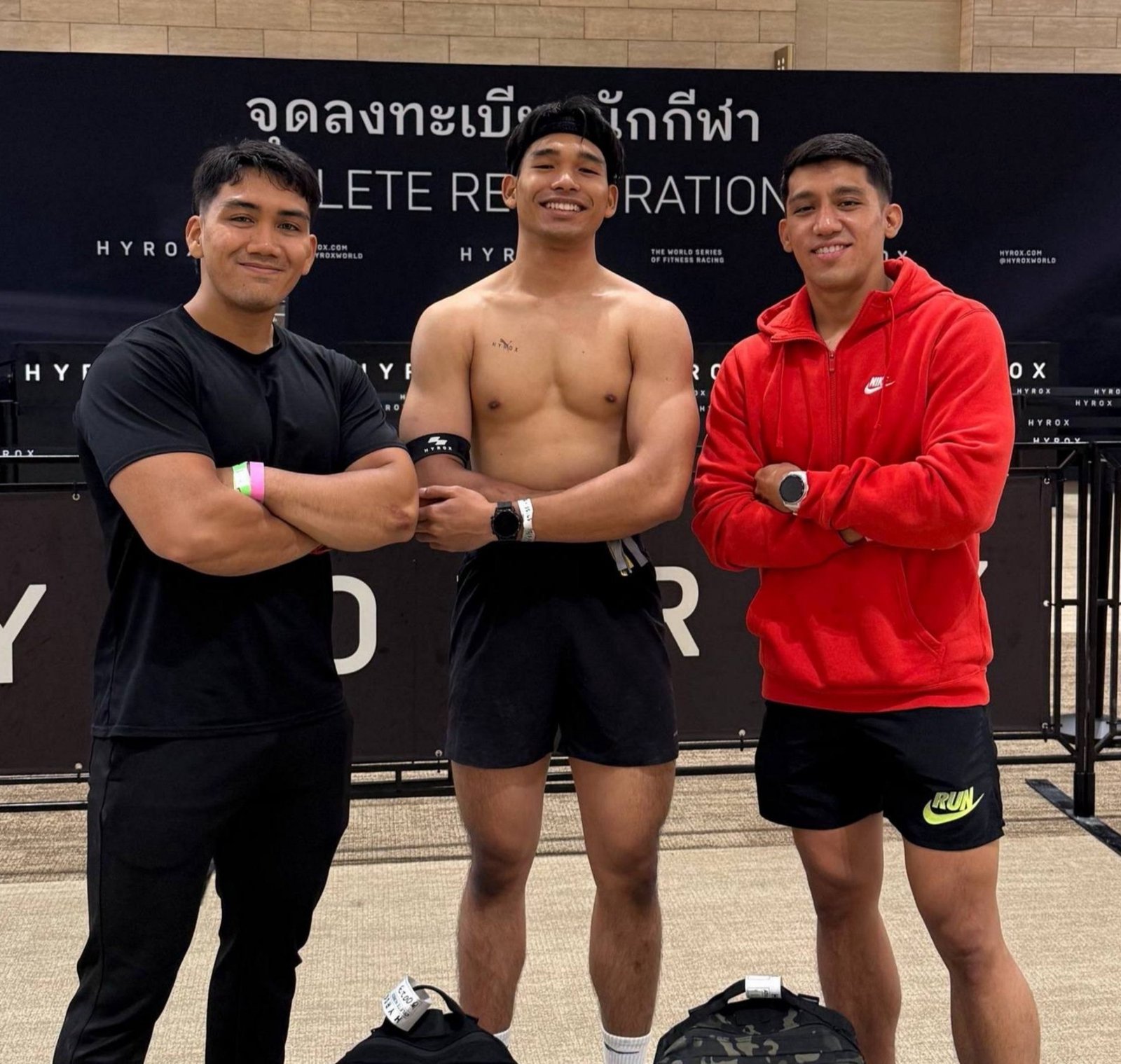 Faris posing with two athletes at a HYROX event